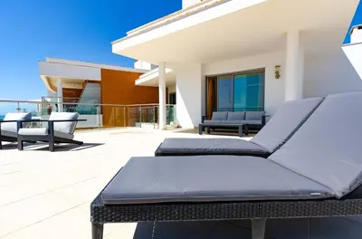 a balcony with two beds on a patio at Penthouse Apartment, Superb sea view 1 Bedroom, Verandas do Mar AT02 in Albufeira