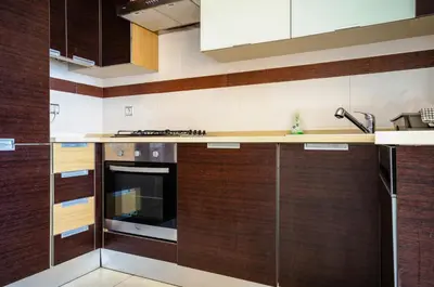 a kitchen with wooden cabinets and a stove at Penthouse Apartment, Superb sea view 1 Bedroom, Verandas do Mar AT02 in Albufeira