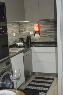 a kitchen with a sink and a counter top at Cosy House in Albufeira