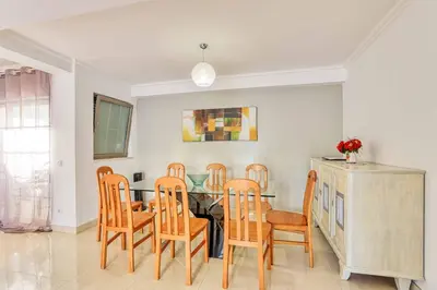 a dining room with a table and chairs at Villa Machado in Albufeira