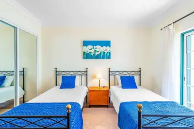 two beds in a room with blue and white at Villa Minerva in Albufeira