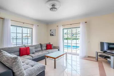a living room with a couch and a television at Villa Minerva in Albufeira