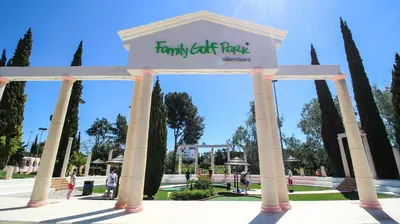 a sign in front of a park with trees at Serenity by the Marina, Vilamoura in Quarteira