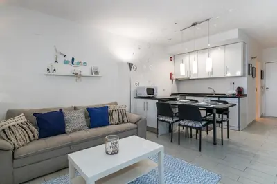 a living room with a couch and a table at Serenity by the Marina, Vilamoura in Quarteira