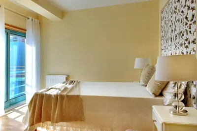 a bedroom with a large bed and a window at Marina Ocean Residence in Albufeira