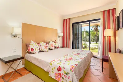 a hotel room with a bed and a balcony at AL - Apartamento Vila Sol F5 E in Vilamoura
