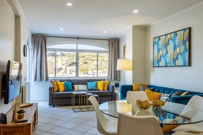 a living room with a couch and a table at Top renoviertes Apartment mit großer Terrasse in Albufeira