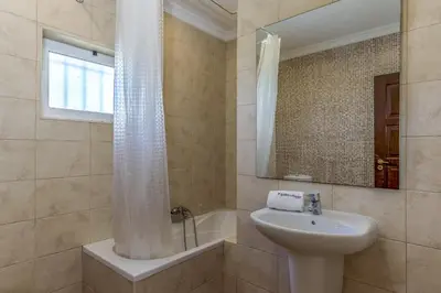 a bathroom with a sink and a mirror and a shower at FLH Albufeira Vila Mira Flat with Pool in Albufeira
