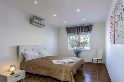 a bedroom with a bed and a window at FLH Albufeira Vila Mira Flat with Pool in Albufeira