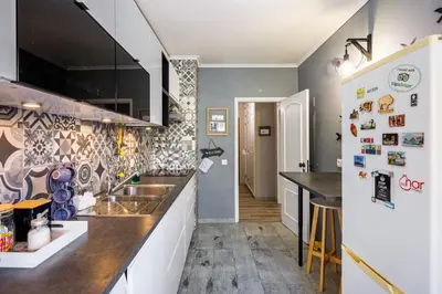 a kitchen with a sink and a refrigerator at Kwadalayo Art Quarters in Faro