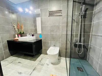 a bathroom with a toilet and a sink and a shower at Kwadalayo Art Quarters in Faro
