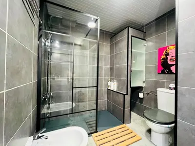 a bathroom with a shower and a toilet and a sink at Kwadalayo Art Quarters in Faro