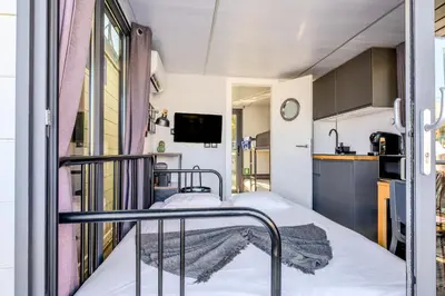 a bedroom with a large bed and a view of the water at The Homeboat Company Albufeira in Albufeira