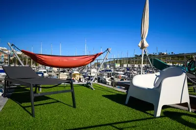 a living room with a couch and a mirror at The Homeboat Company Albufeira in Albufeira