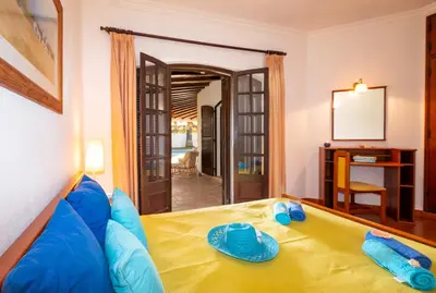 a living room with a bed and a mirror at Villa Atlas by Algarve Vacation in Albufeira