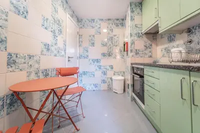 a small kitchen with blue and white tiles at Marina Design T1 in Albufeira