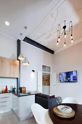 a kitchen and a living room with a table in a room at Pereiras House of Charm - Downtown in Faro