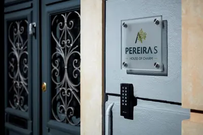a sign on the door of a building with a entrance at Pereiras House of Charm - Downtown in Faro