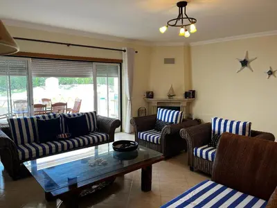 a living room with couches and a coffee table at Paradise Beach Villa in Albufeira