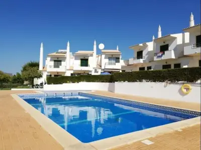 a swimming pool in front of a building at Joia da Galé House by Stay ici Algarve Holiday Rental in Albufeira
