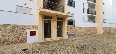 a building with a door and a stone wall at Apartamento Costa in Albufeira
