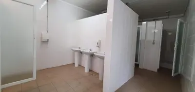 a white bathroom with two sinks and a shower at Apartamento Costa in Albufeira