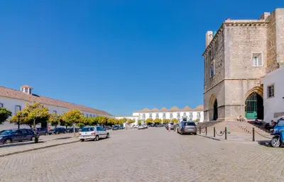 a street with cars parked in front of a building at TREM - LOCATED IN OLD CITY - FARO in Faro