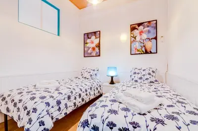 two beds in a room with white walls at TREM - LOCATED IN OLD CITY - FARO in Faro
