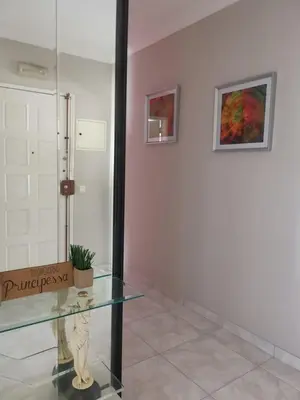 a glass table with a statue in a room at Penha House in Faro