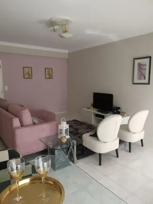a living room with a couch and chairs and a table at Penha House in Faro