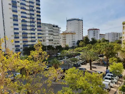 a parking lot in a city with tall buildings at Solaris- Familiar, Wifi, Totalmente Equipado in Quarteira