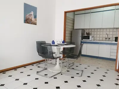 a kitchen with a table and chairs in a room at Solaris- Familiar, Wifi, Totalmente Equipado in Quarteira