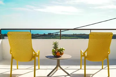 two chairs and a table on a balcony at Villa Marrachinho in Albufeira