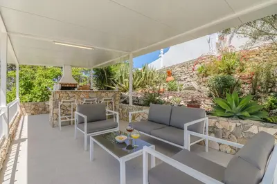 a patio with two chairs and a table at Villa Redonda in Loulé