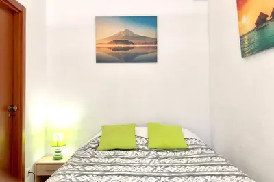 a bedroom with a bed with two green pillows at Albufeira Jardim l old town and beach - Hawai in Albufeira