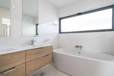 a bathroom with a tub and a sink and a mirror at Colinas do Golfe Vilamoura Sun by SAPvillas in Vilamoura