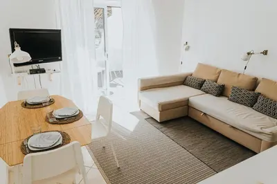 a living room with a couch and a table at Soleil Apartment in Quarteira