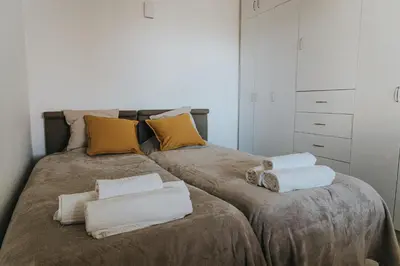 a bedroom with two beds with towels on them at Soleil Apartment in Quarteira