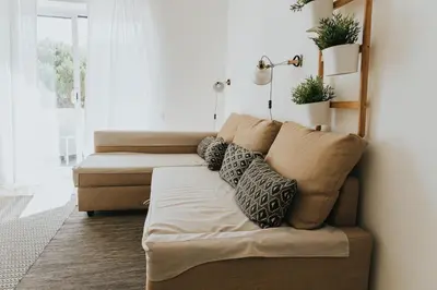 a living room with a couch with pillows on it at Soleil Apartment in Quarteira