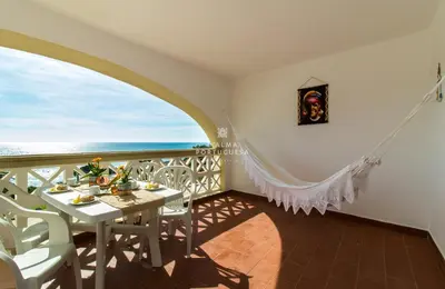 a dining room with a table and a view of the ocean at Apartment Aveiros Beach- D´Alma Amado in Albufeira