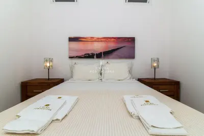 a bedroom with a bed with two towels on it at Apartment Aveiros Beach- D´Alma Amado in Albufeira