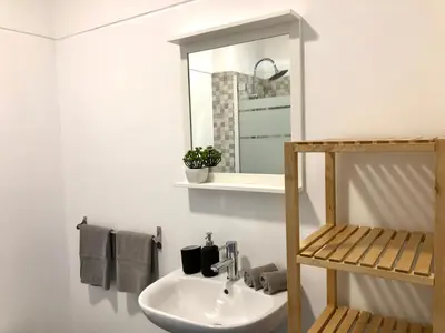a bathroom with a sink and a mirror and towels at Albufeira I old town and city center in Albufeira