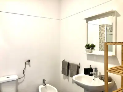 a bathroom with a sink and a toilet and a mirror at Albufeira I old town and city center in Albufeira