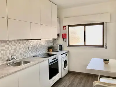 a white kitchen with a sink and a microwave at Albufeira I old town and city center in Albufeira