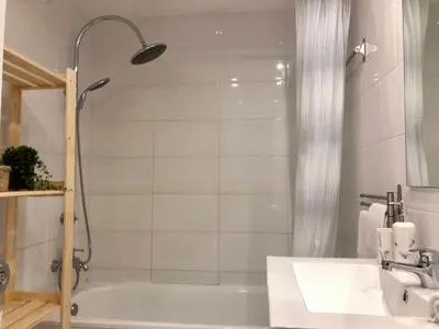 a bathroom with a tub and a sink and a shower at Cozy and Stylish Studio Apt - just 800m from the beach in Albufeira