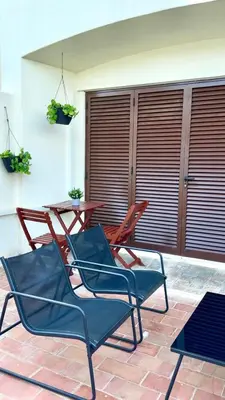 two chairs and a table on a patio at Cozy and Stylish Studio Apt - just 800m from the beach in Albufeira