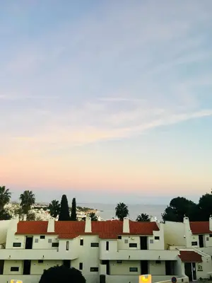 a view of buildings with the ocean in the background at Cozy and Stylish Studio Apt - just 800m from the beach in Albufeira