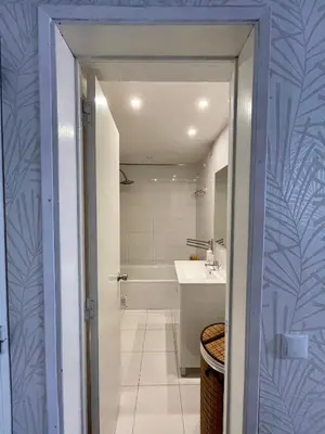 a bathroom with a sink and a bath tub at Cozy and Stylish Studio Apt - just 800m from the beach in Albufeira