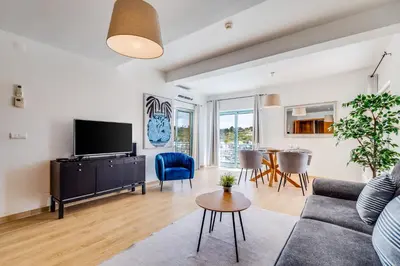 a living room with a couch and a table at Sunny Marina View Apartment Albufeira 1B-3C in Albufeira
