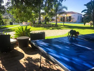 a man is working on a blue table at Elegant villa with sea view in Loulé + private pool in Loulé